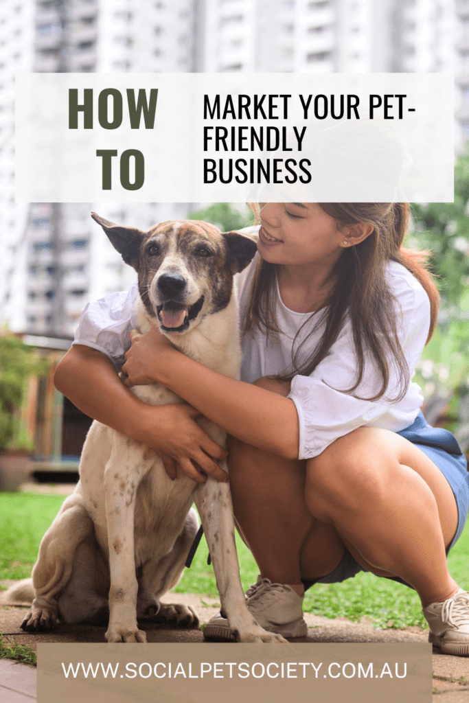 A woman crouches down beside a small dog in a cozy cafe setting. She smiles warmly as she interacts with her furry companion, who looks up at her with a wagging tail.